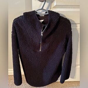 H&M black cozy Sherpa pullover with zippered detail and hood.